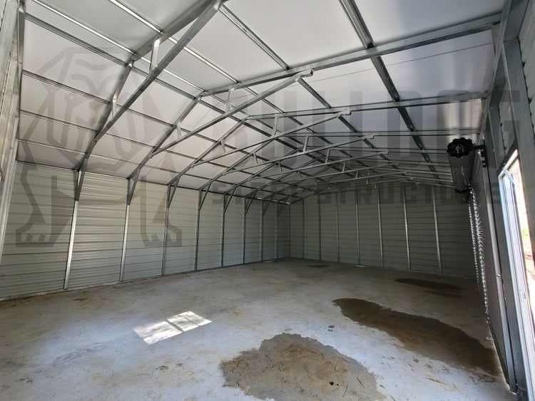 inside of a metal garage with doors open