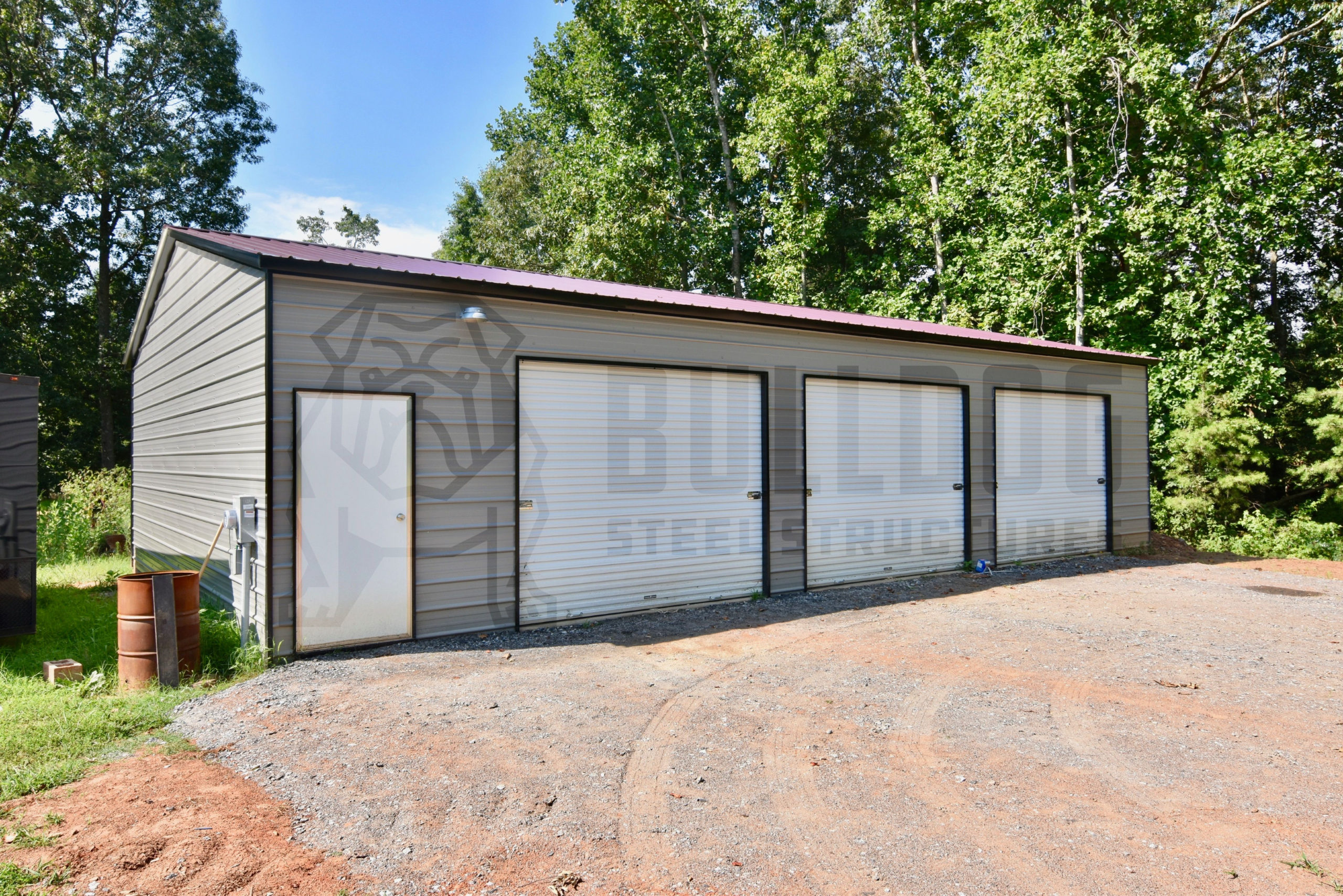 Three-car garage with gray siding