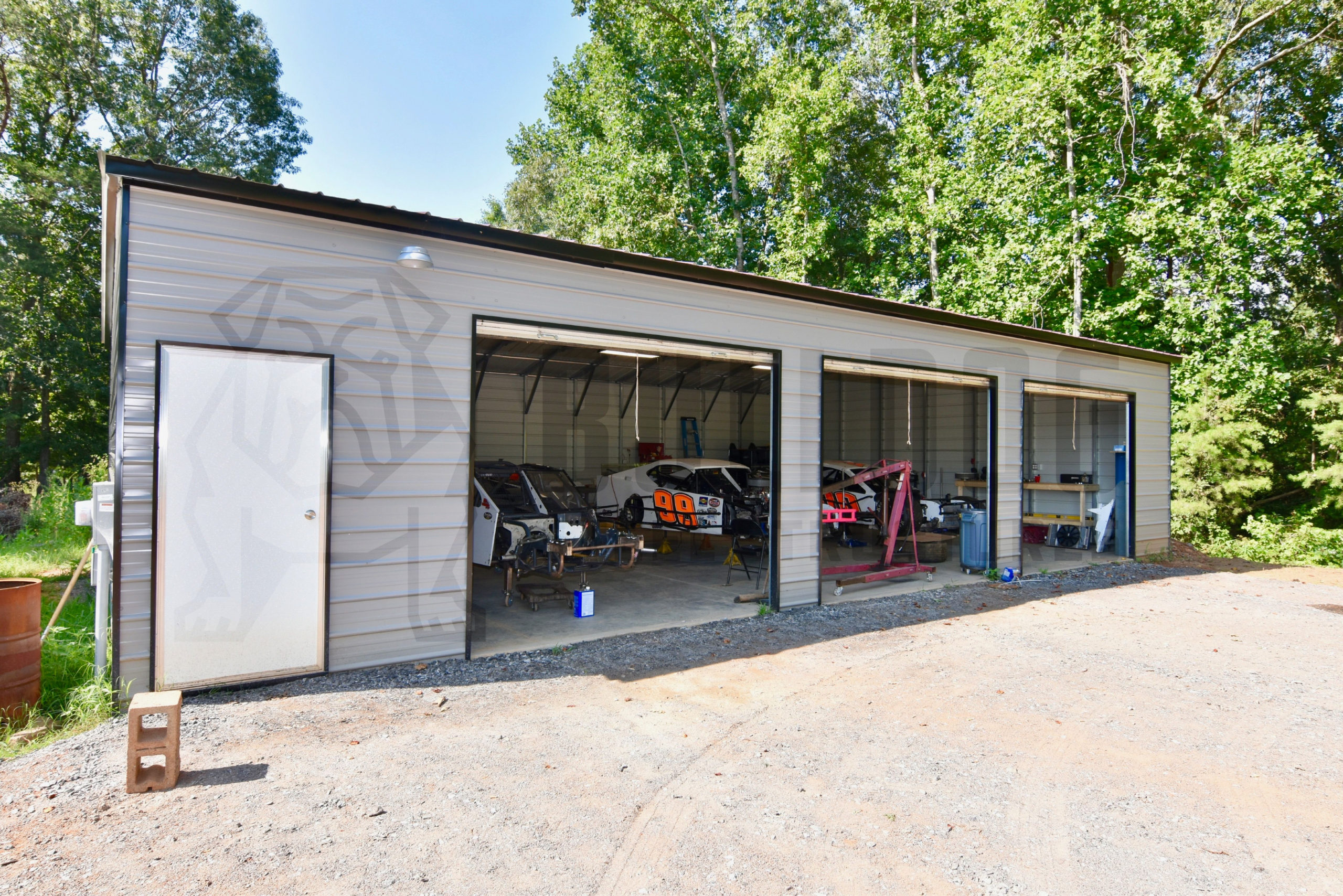 Three-car garage with gray walls and white door