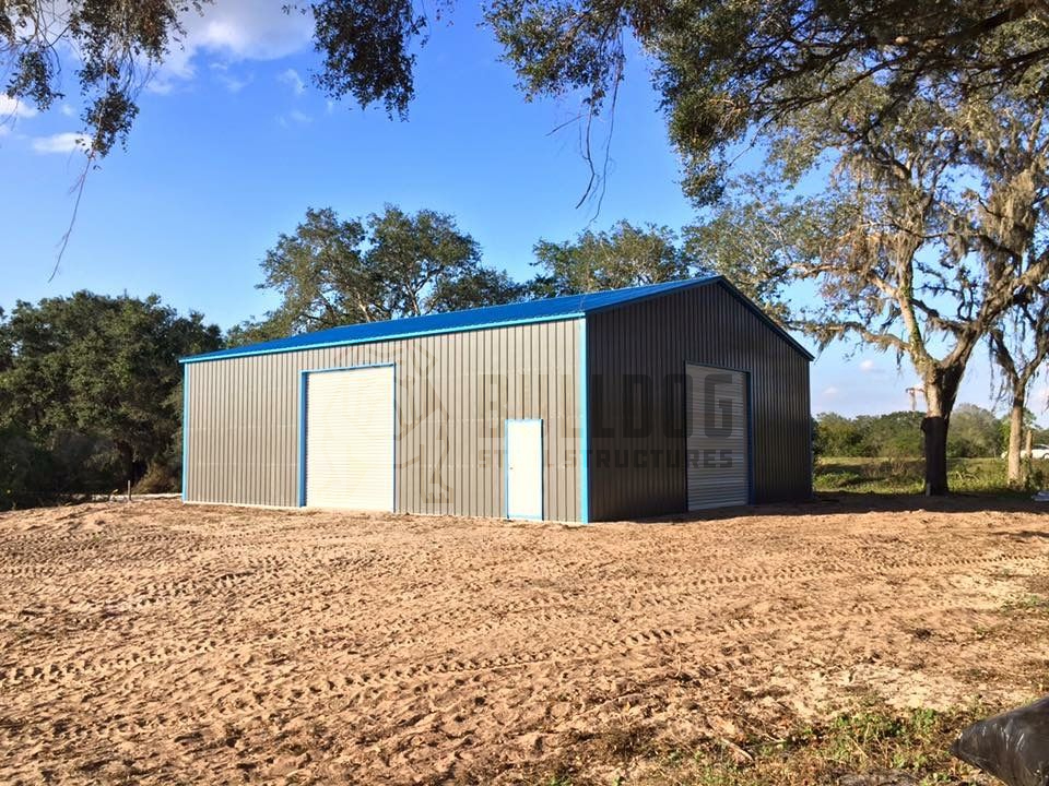 Metal storage building with blue trim and roof
