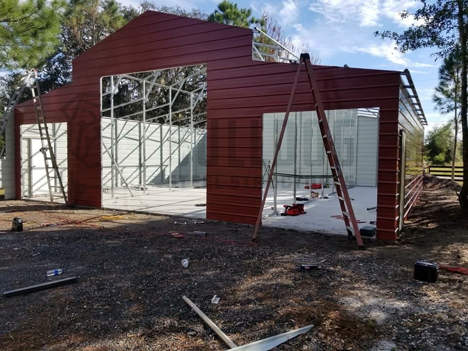 Red metal barn under construction