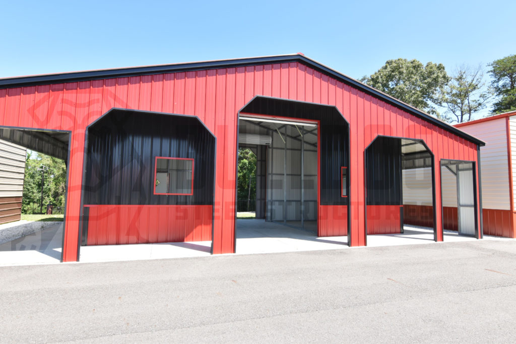 Exterior of custom red barn with black trim.