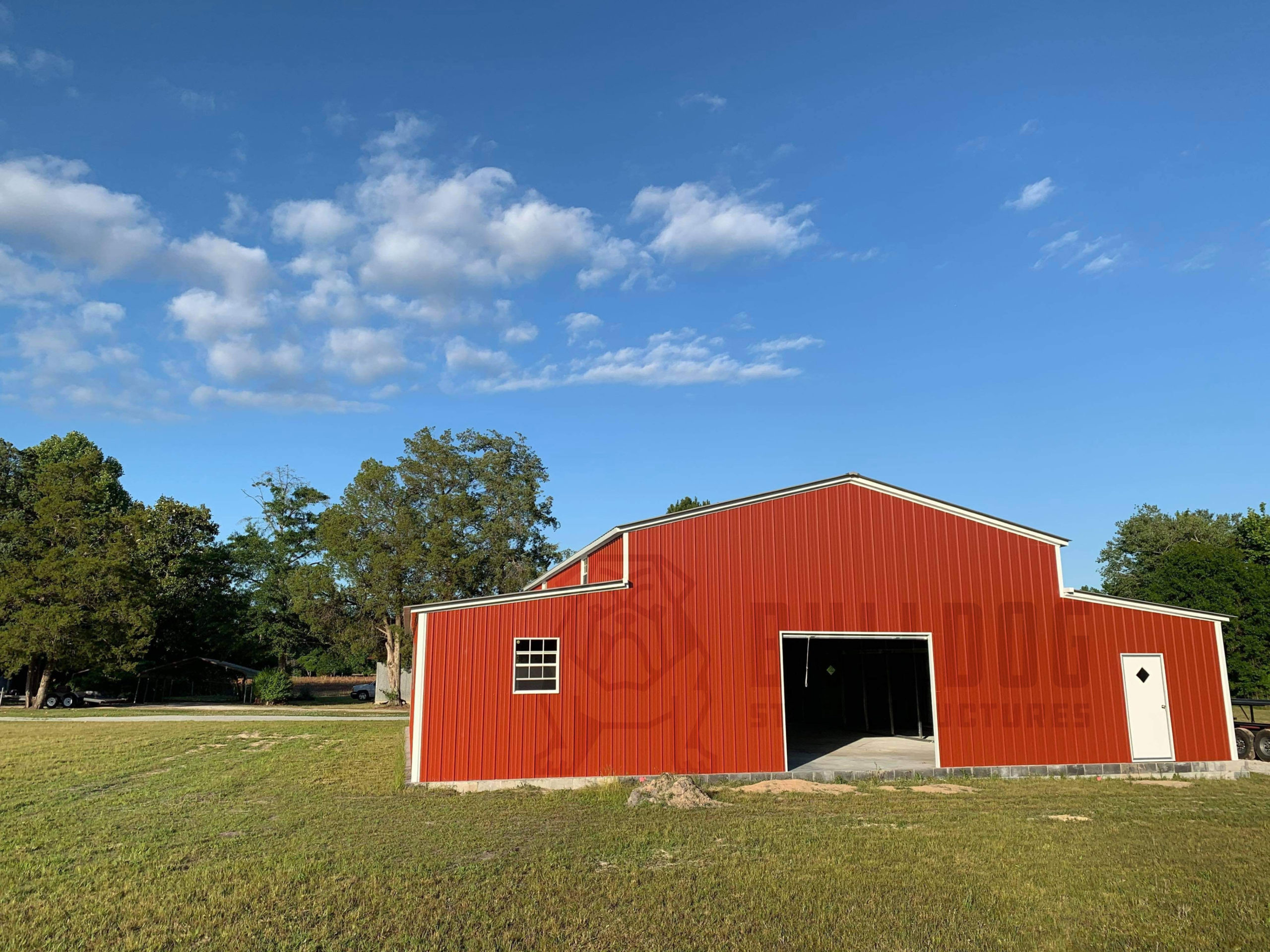 Exterior of red barn with large open door