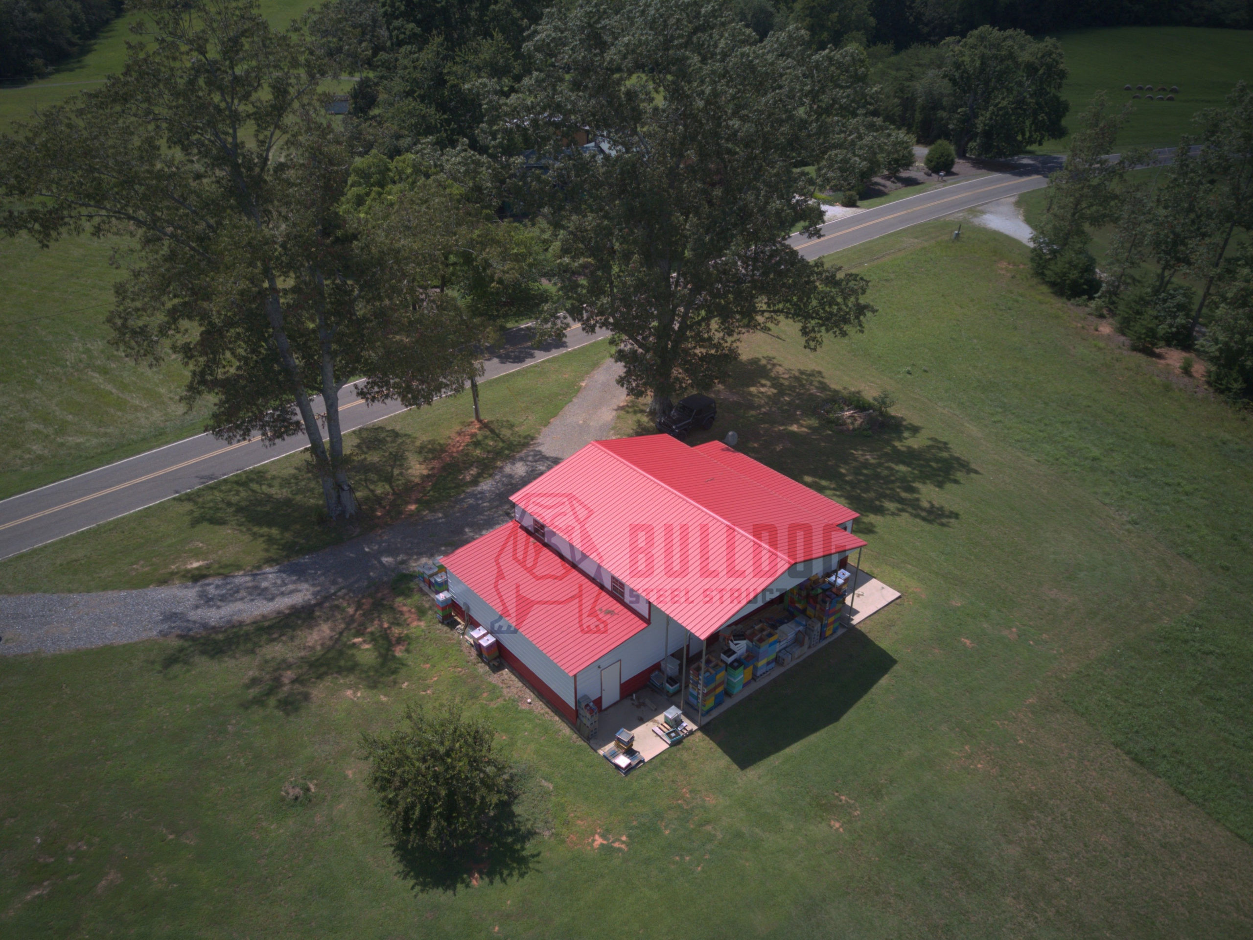 Aerial view of barn with white walls and red roof