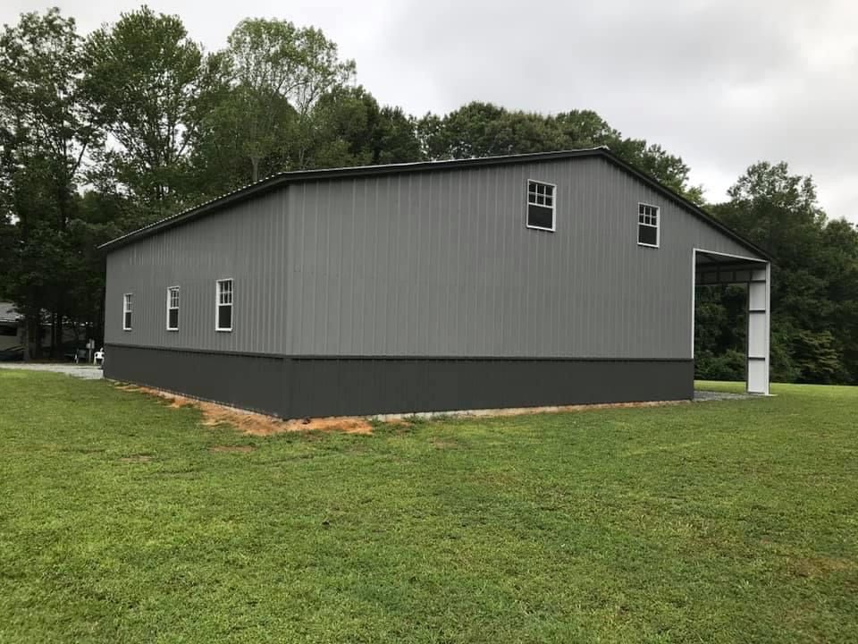 All gray custom metal barn with windows installed