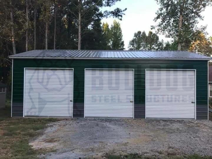 green metal garage with three doors