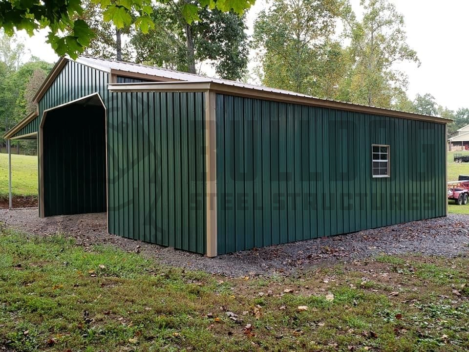Exterior of barn with green walls and car port attached
